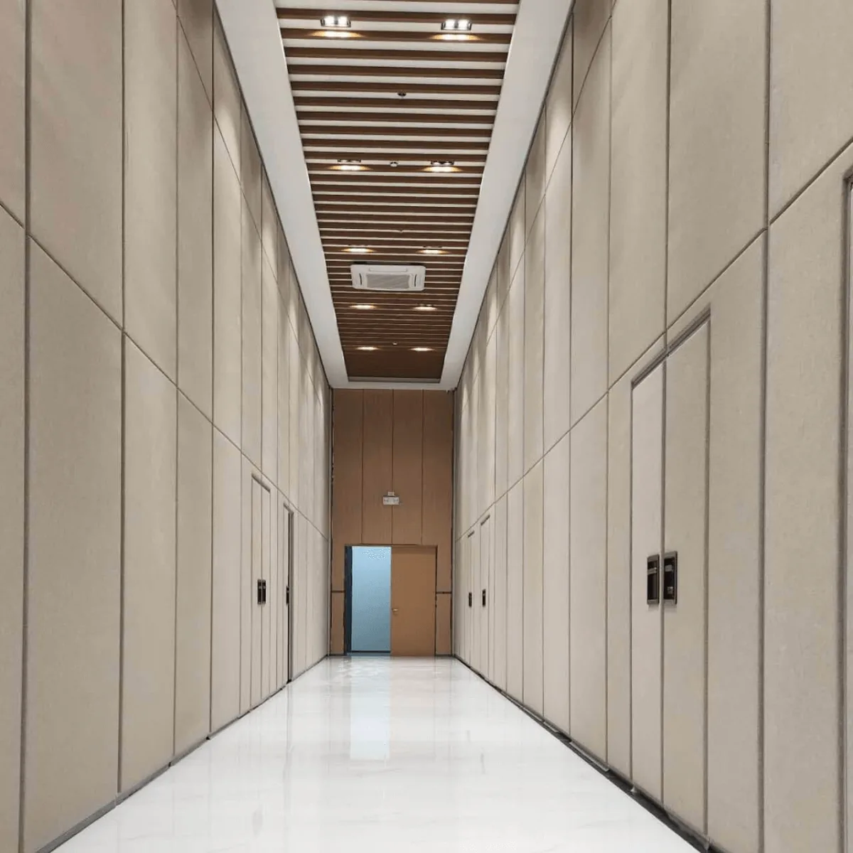 Installers fitting an operable wall's overhead track and acoustic panels
